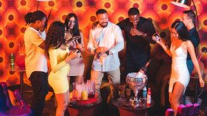 Friends having drinks in a booth at Boogie Nights.