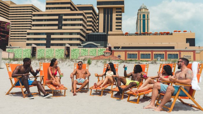 People sitting in chairs on the beach.