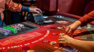 Hands grabbing chips on casino card table