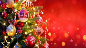 A beautifully decorated Christmas tree on a red background
