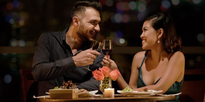 Couple toasting wine at romantic dinner. Couple toasting wine at romantic dinner.