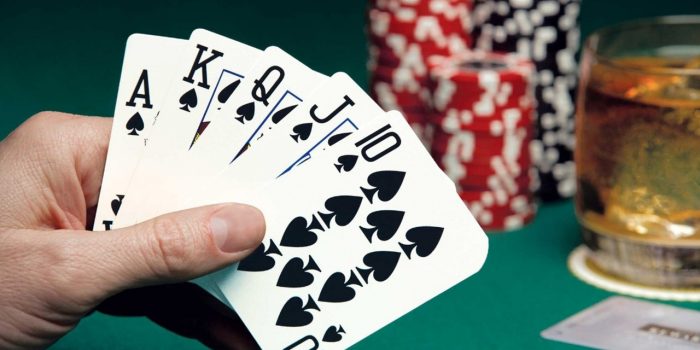 Hand holding poker cards.
