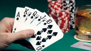 Hand holding poker cards.