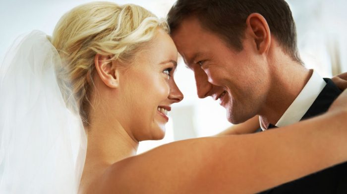 Bride And Groom Looking Into Each Others Eyes Smiling
