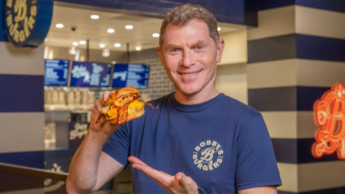 Bobby Flay holding a cheese burger
