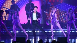 Donny Osmond performing with live band and backup dancers