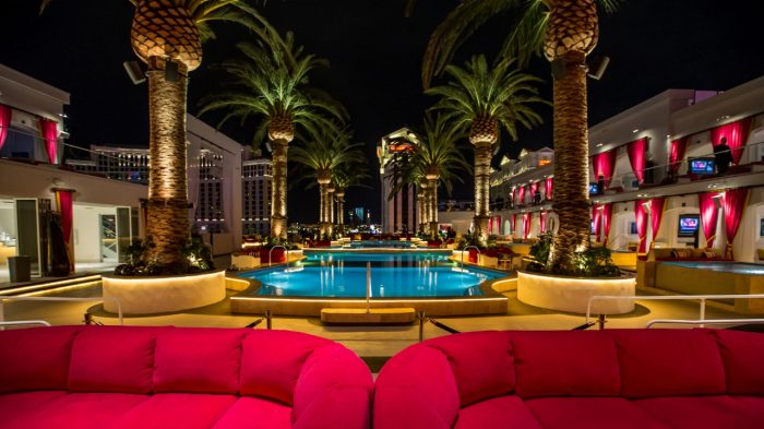 View Of Drais Pool At Night Showing Cabanas, Couches And Palm Trees At The Cromwell Hotel