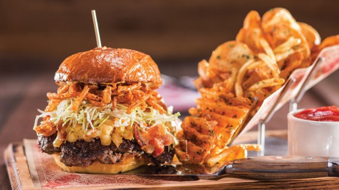 Huge burger with a side of curly cut fries from Guy Fieri's Vegas Kitchen and Bar in LINQ Hotel + Experience