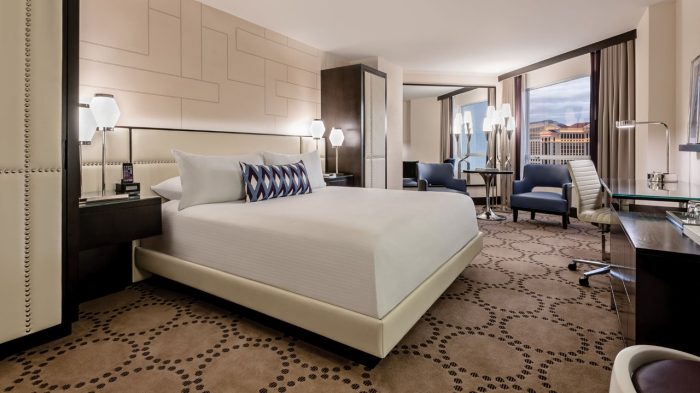 Photo Of Guests Lounging By The Pool With A Drink In Their Hands At Harrah's Las Vegas