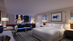 Photo of Versailles Tower King bedroom with sofa near window, workspace and task chair at Paris Las Vegas