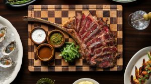 Steak sliced on a cutting board from Diner Ross Steakhouse