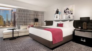 Photo of King Size Bed, Nightstand, Couch, And Window At Planet Hollywood