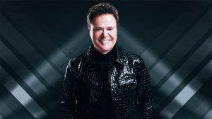 Donny Osmond wearing a black jacket.