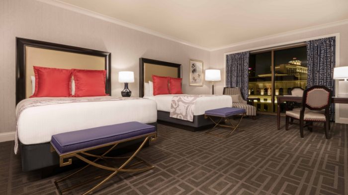 Photo Of Palace Tower Premium Room Showing Two Queen Beds, Desk, Chairs, And A Small Sitting Area Near The Window At Caesars Palace Las Vegas.