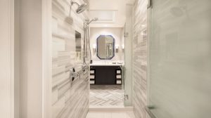 Interior view of restroom with large vanity and dual shower