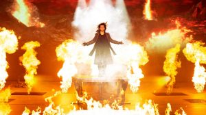 Criss Angel on stage surrounded smoke.