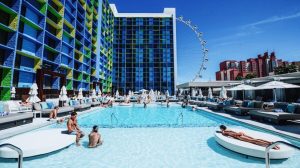 Photo Of The Pool During The Day With Guests Swimming And Lounging And The High Roller In Back Ground At The Linq Las Vegas