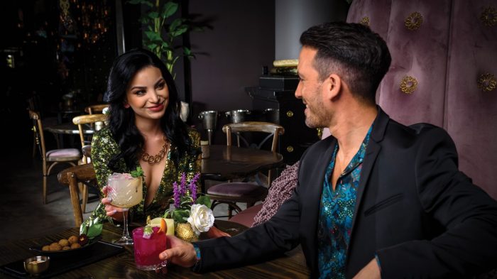 Woman and man having drinks at Vanderpump Cocktail Garden