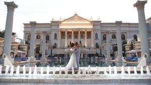 Bride and Groom embracing by the Neptune Pool at Caesars Palace