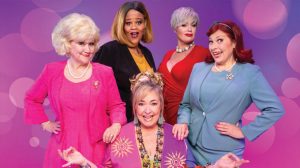 Cast of Menopause the Musical posing in front of a purple background