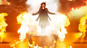 Criss Angel on the stage, surrounded by fire.