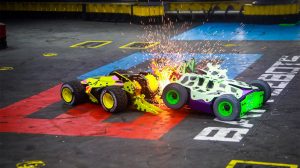 Green and White Tank attacking a Yellow Tank at Battle Bots at Horseshoe Las Vegas. Sparks Flying in the air during the attack.