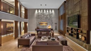 View Of Nobu Penthouse Showing A Living Room With Couches, Coffee Table, A Mounted TV, A Purple Pool Table, Staircase Leading To Second Floor, And View Of Hallway For The Upstairs and Downstairs Inside Nobu Hotel At Caesars Palace