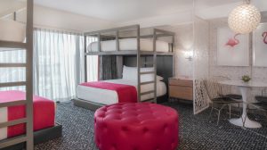 Bunk Bed Suite bedroom showing four beds, two below with two bunks as well as a seating area for 4