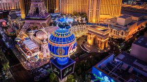 Paris Las Vegas at night with view of the arch and pool