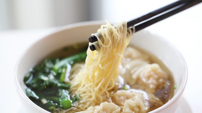 Wonton soup with chopsticks.
