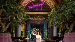 Lisa Vanderpump posing at the entrance of Vanderpump Cocktail Garden