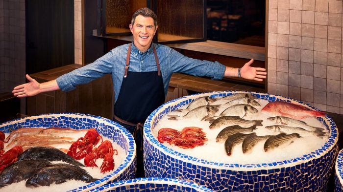Chef Bobby Flay presenting fresh seafood displayed on ice