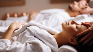 Couple getting a massage in a treatment room.