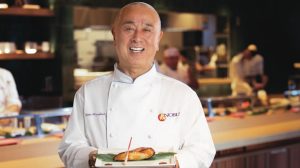 Chef Nobu holding a dish