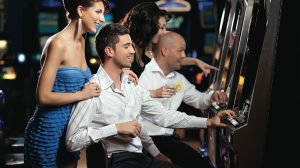 Couple playing slot machines at Planet Hollywood Las Vegas