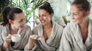 Three young women drinking tea at spa resort