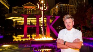 Gordon Ramsay Standing By The Hell's Kitchen Sign At Caesars Palace