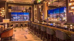 View Inside Vista Cocktail Lounge Showing Bar Top With Stools, Cushioned Chairs And Tables And Lounge Area Inside Caesars Palace Las Vegas