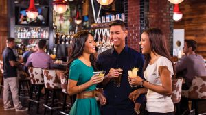 Image of a group of people enjoying food and drinks at Guy Fieri's Las Vegas Kitchen & Bar