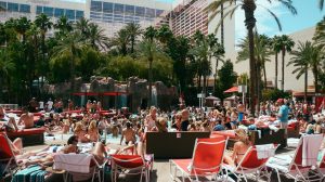 View Of Pool Area Showing a Crowd Of People Lounging On Chairs, And Enjoying The Swimming Pool At Flamingo Las Vegas