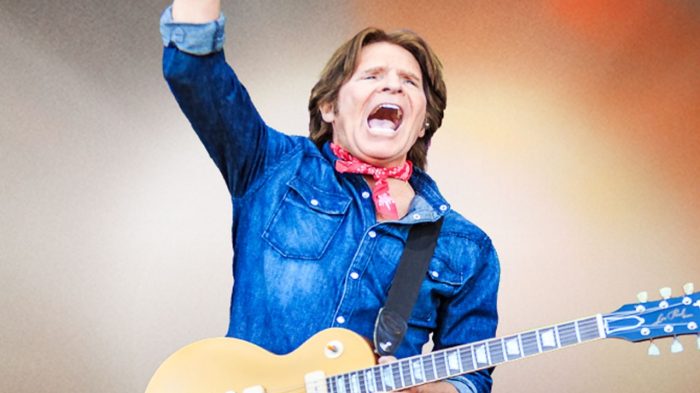 John Fogerty with Guitar and Tie Dye Background