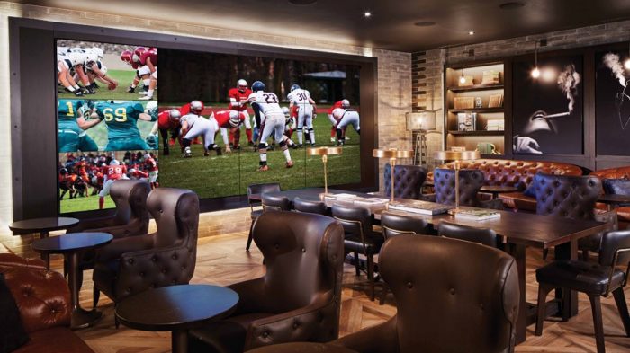 Interior View Of Montecristo Cigar Lounge Showing Large TV's, Cushioned Seating, And Tables Inside Caesars Palace Las Vegas