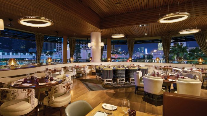 Giada dining room with large windows and view of the strip.