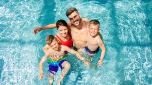 Family in a pool together.
