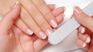Image of a Woman Filing Another Woman's Nails