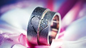 Image Of Wedding Bands On Top Of Pink And White Fabric