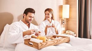 Couple enjoying in room dining.