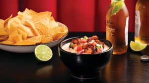 Sizzle & Salt white queso and chips with beer