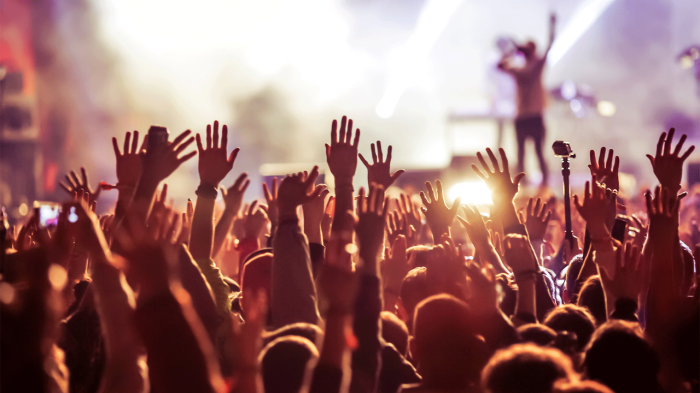 Crowd at a Concert with Birght White and Yellow Lights