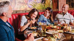 Two couples enjoying Mexican food and drinks.